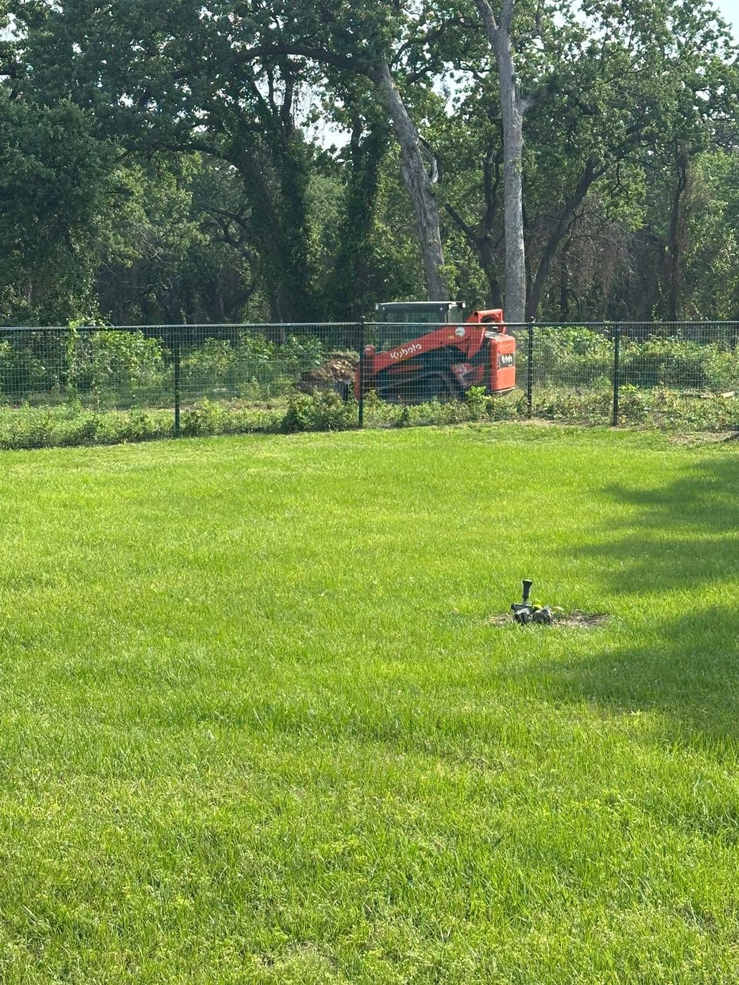 Field fence installation in progress on a rural property