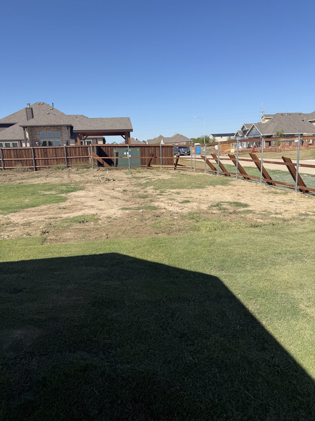 Wood privacy fence corner on a new construction lot