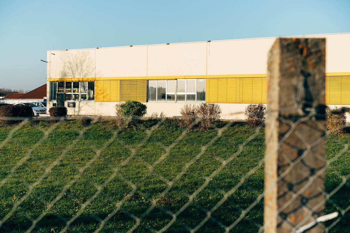 Chain link perimeter fencing around a commercial building
